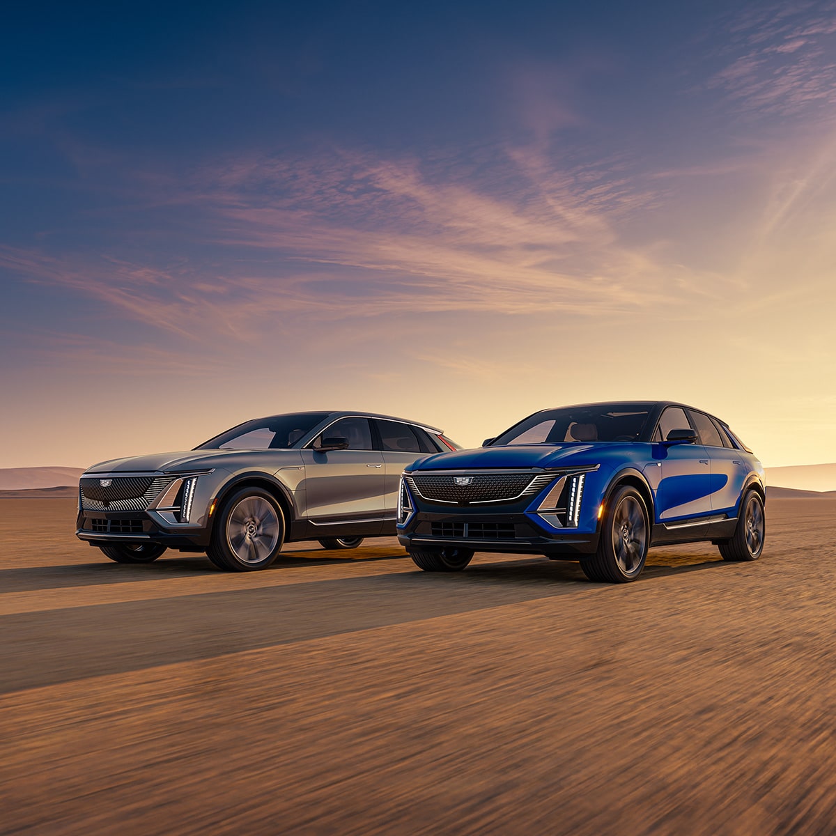 Two Cadillac SUVs Parked in the Desert Under a Beautiful Sunrise