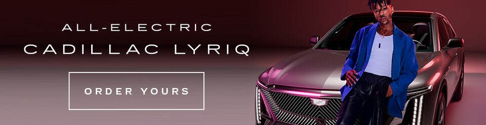 Dario Calmese Posing in Front of the All-Electric Cadillac LYRIQ 