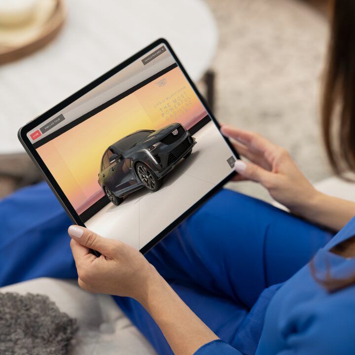 A Woman Views A Walkaround Video of the Cadillac Escalade from the Comfort of her Home