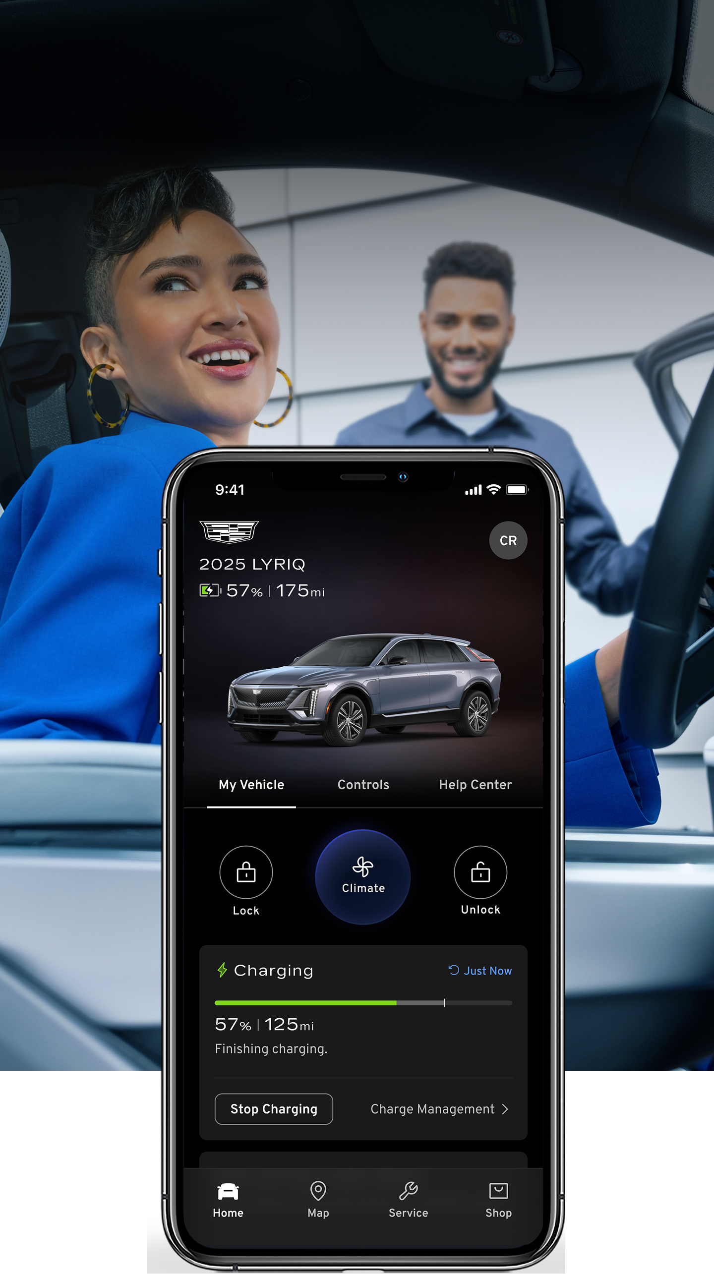 A SmartPhone Showcasing the Certified Service App in Front of A Woman in Her Vehicle and a Service Technician Standing Next to Her Vehicle