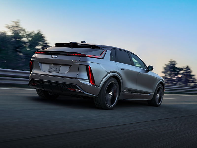 The Rear Three-quarter of a Cadillac LYRIQ Driving Down the Road