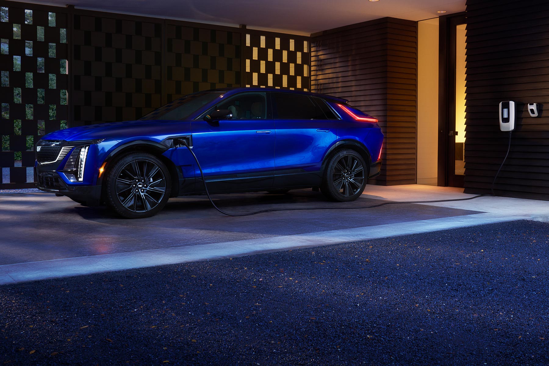 Blue 2027 Cadillac LYRIQ Parked at a Residential EV Charging Station.