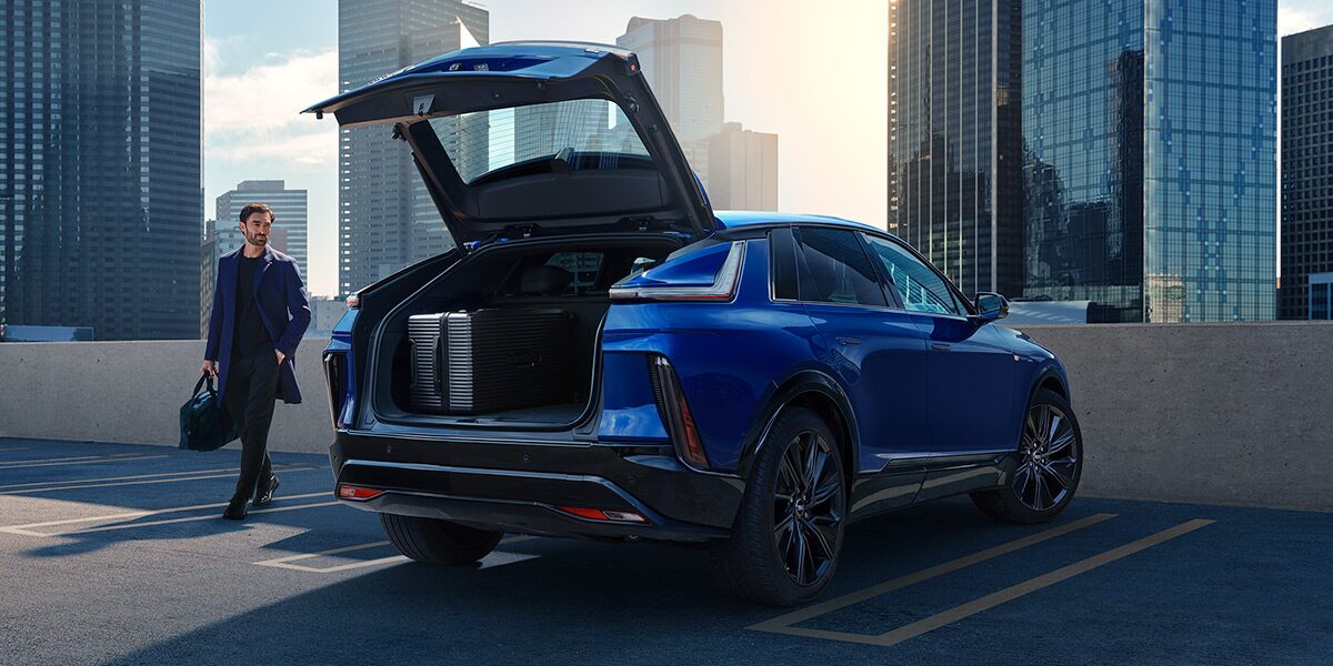 2027 Cadillac LYRIQ With the Rear Liftgate Open in an Urban Parking Area.