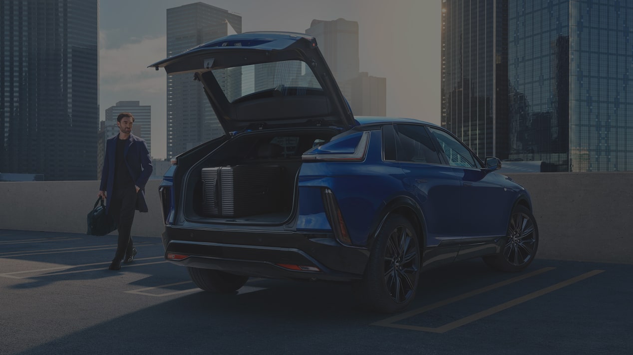 2027 Cadillac LYRIQ With the Rear Liftgate Open in an Urban Parking Area.