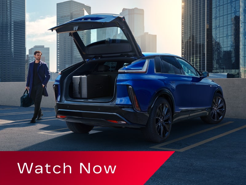 Video Thumbnail Showing a 2027 Cadillac LYRIQ With the Rear Liftgate Open in an Urban Parking Area.