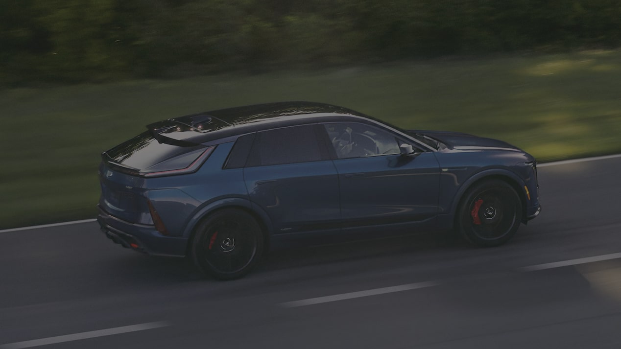 Blue 2027 Cadillac LYRIQ Driving on a Road.