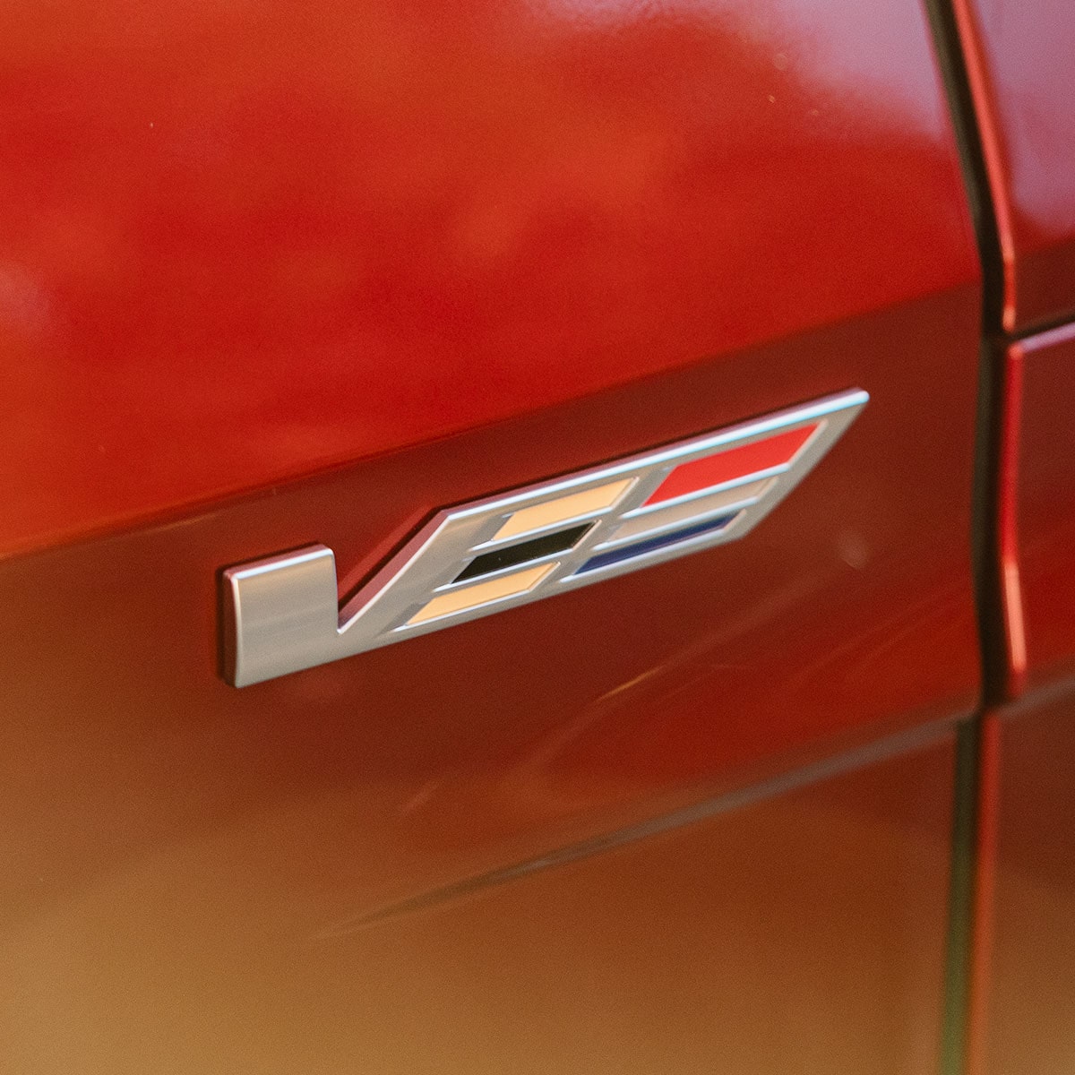 V-Series Badge on a Red 2027 Cadillac LYRIQ-V.