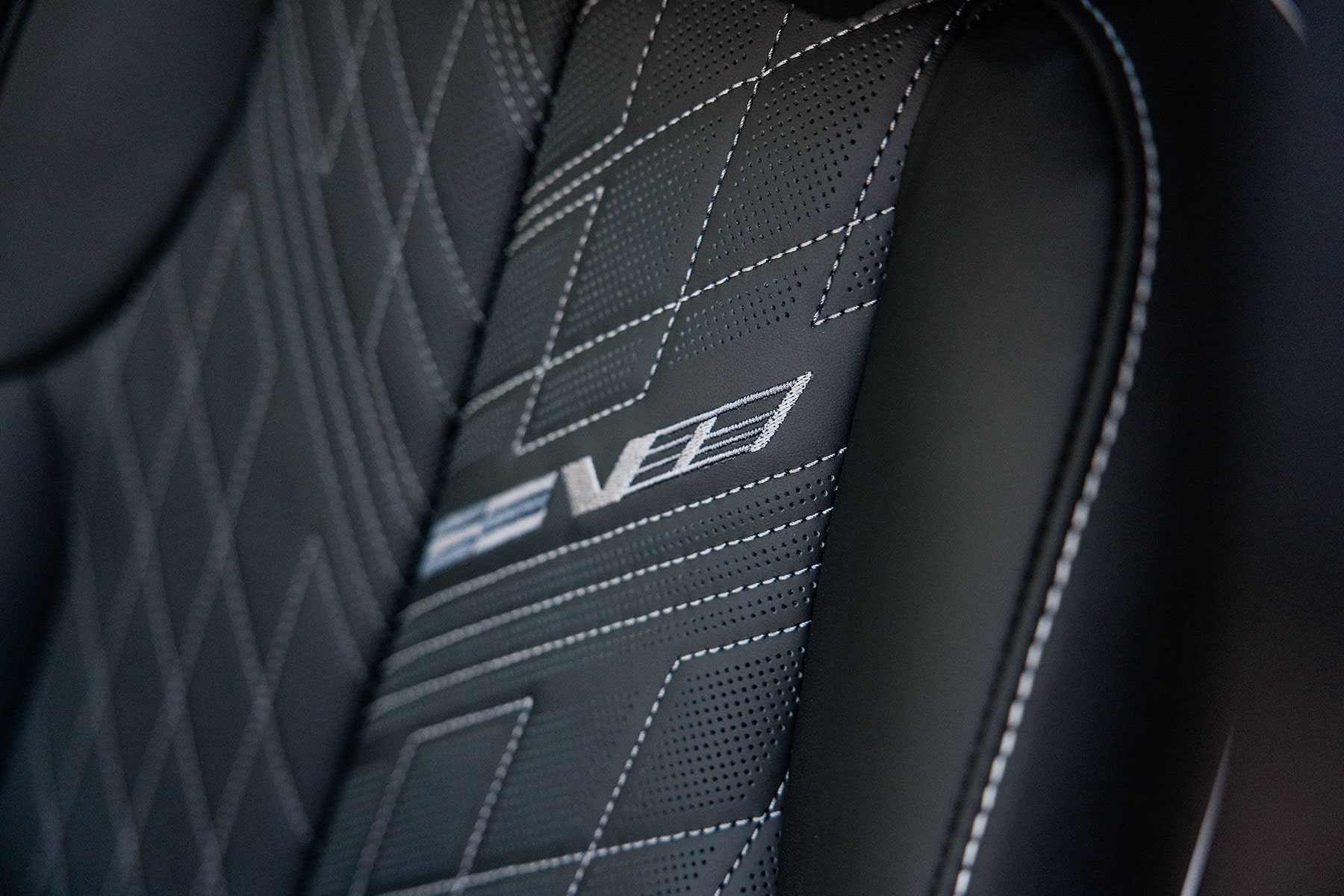 2027 Cadillac LYRIQ-V Front Seat With V-Series Performance Badging and Patterned Upholstery.