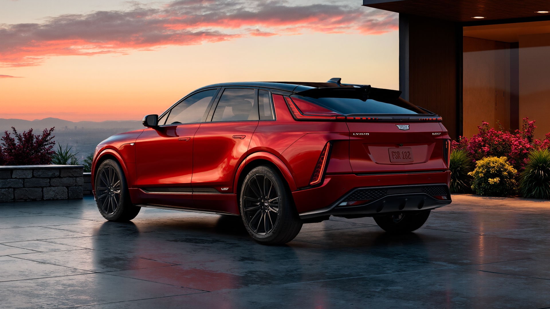 Rear Three-Quarter View of a Red 2027 Cadillac LYRIQ-V Parked Outside a Modern Home at Sunset.