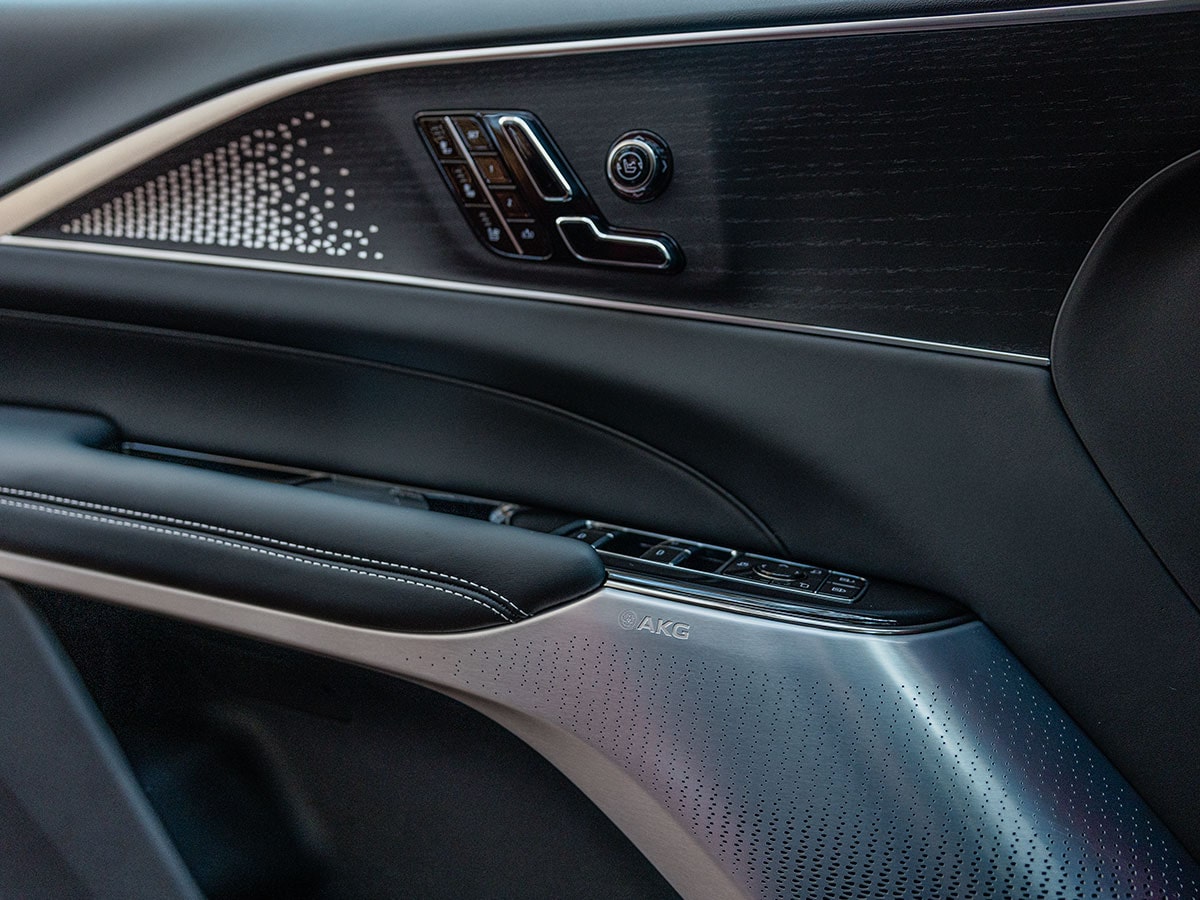 2027 Cadillac LYRIQ-V Door Panel With Metal Speaker Grille and Performance Badging.