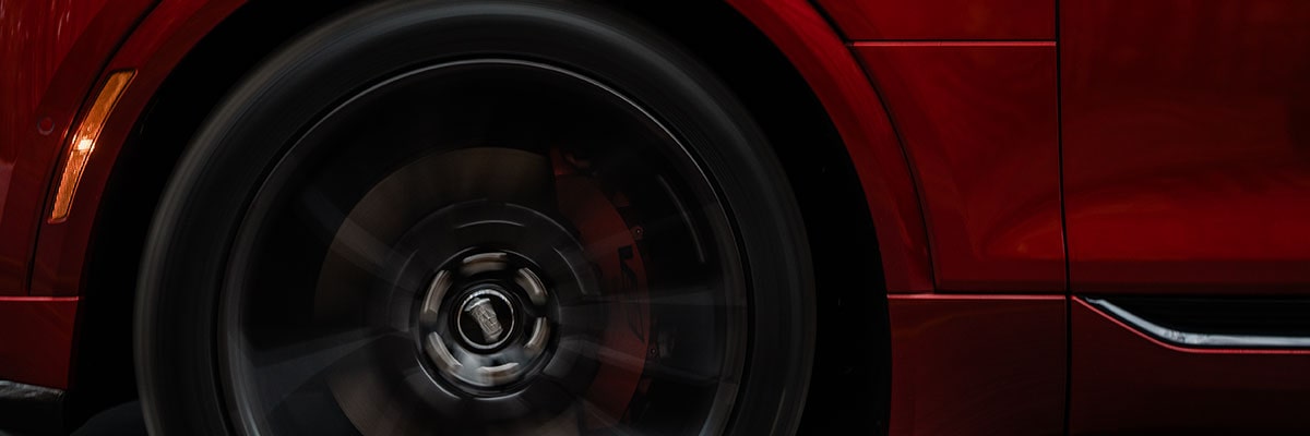 Front Wheel of a Red 2027 Cadillac LYRIQ-V in Motion.