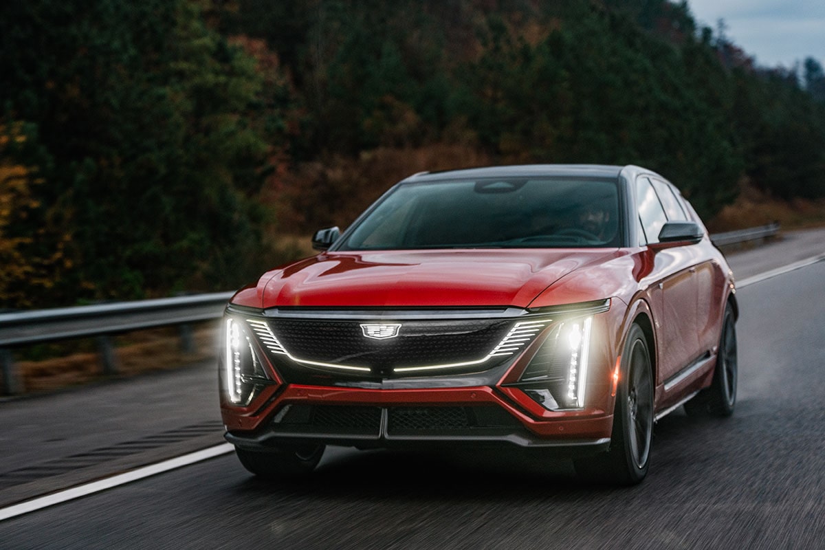 Front View of a Red 2027 Cadillac LYRIQ-V Driving on a Road.