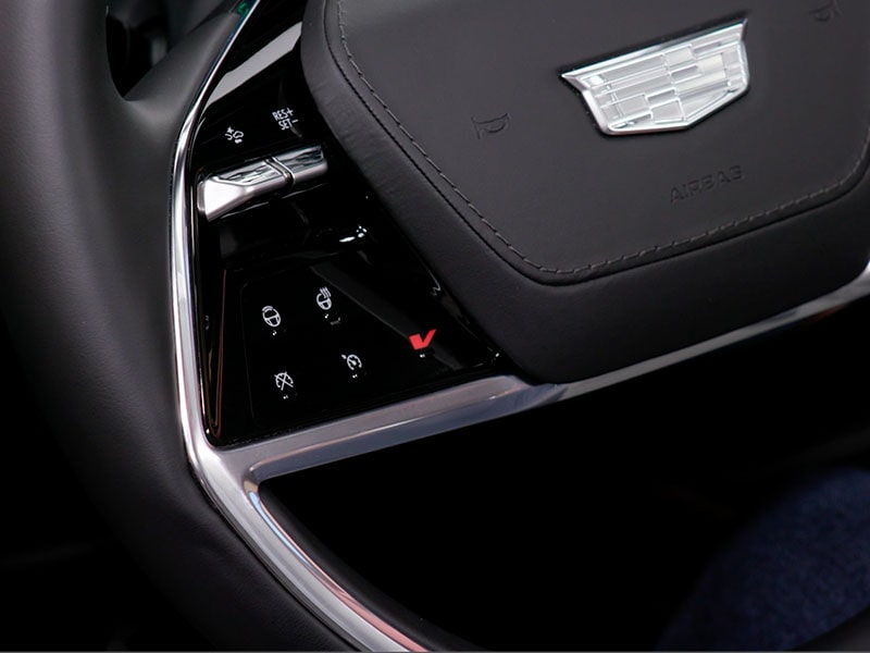 Close-up of the V Button on the 2027 Cadillac VISTIQ Steering Wheel
