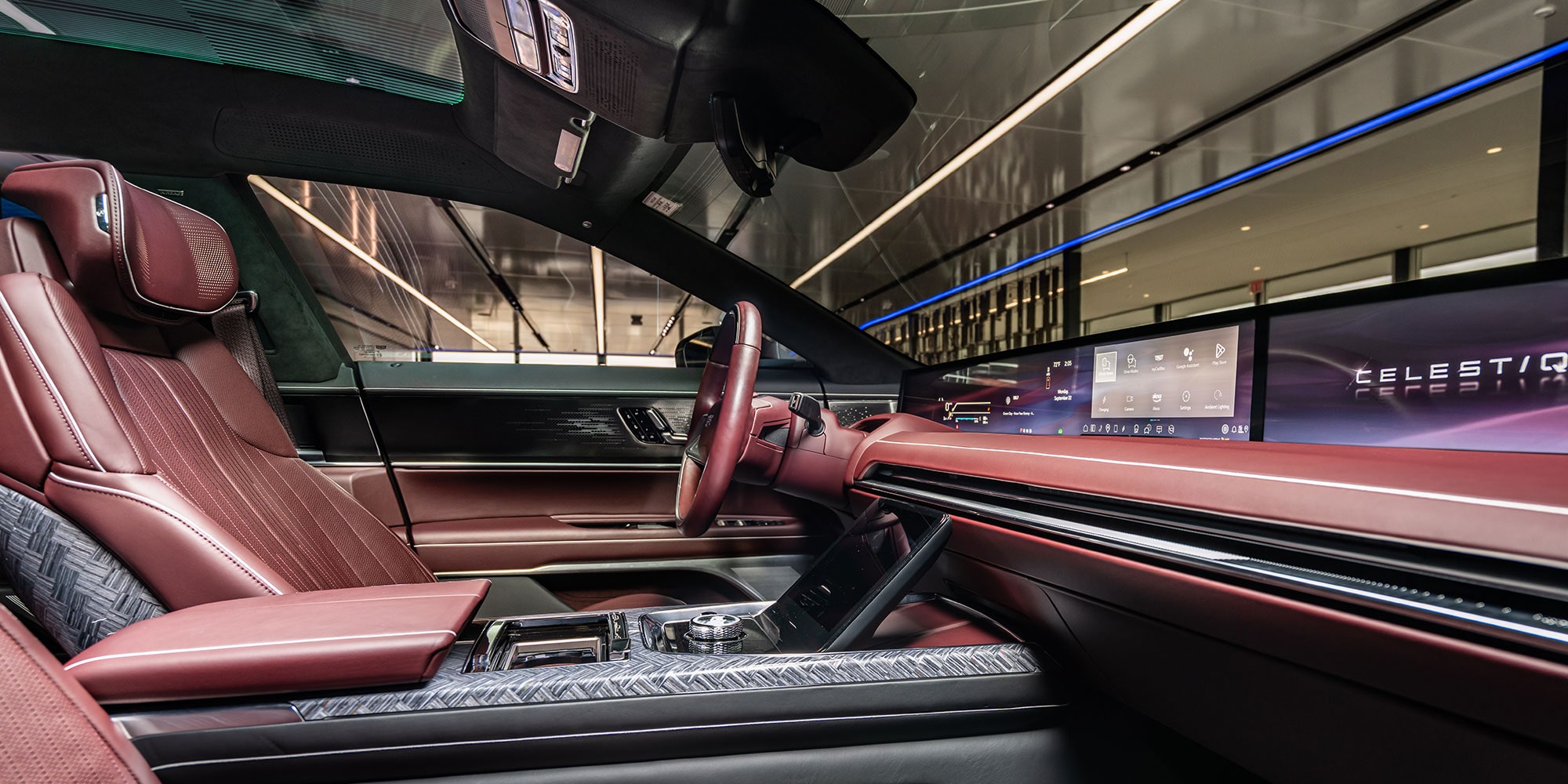 An Interior View of the Cadillac CELESTIQ Driver's Side, Featuring Rich Brown Leather Upholstery, a Steering Wheel, and a Wide Horizontal Screen.