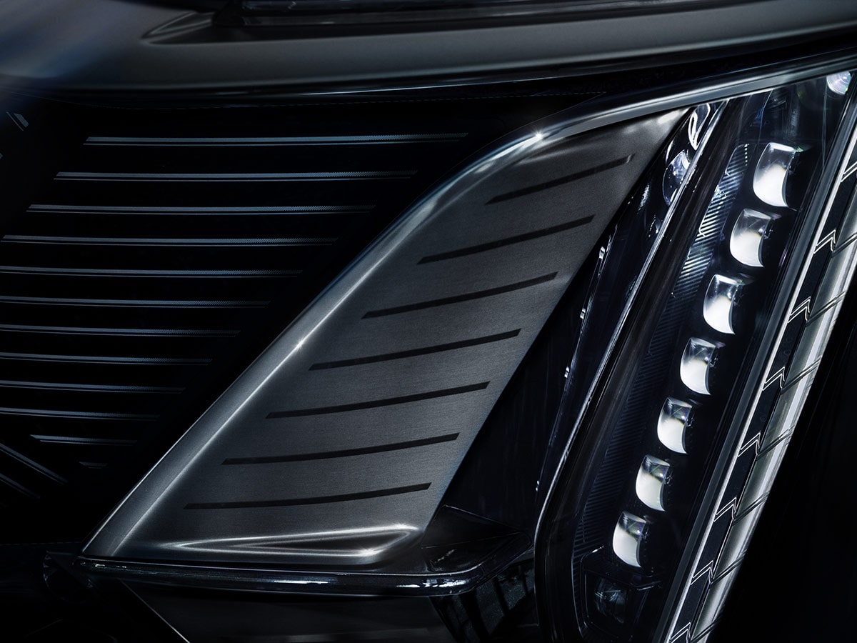 A Close-Up View of the Front Fascia of a Cadillac CELESTIQ Highlighting the Black Grille, Sculpted Bodywork, and Vertical LED Lighting Elements.