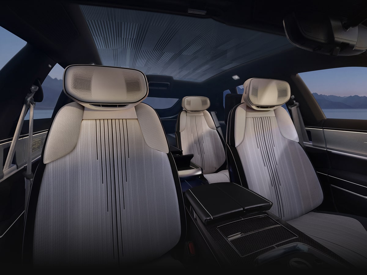 The Interior of a Cadillac CELESTIQ Featuring Four Sculpted White Leather Seats, a Full-Length Center Console, and a Panoramic Glass Roof Above the Passenger Cabin.