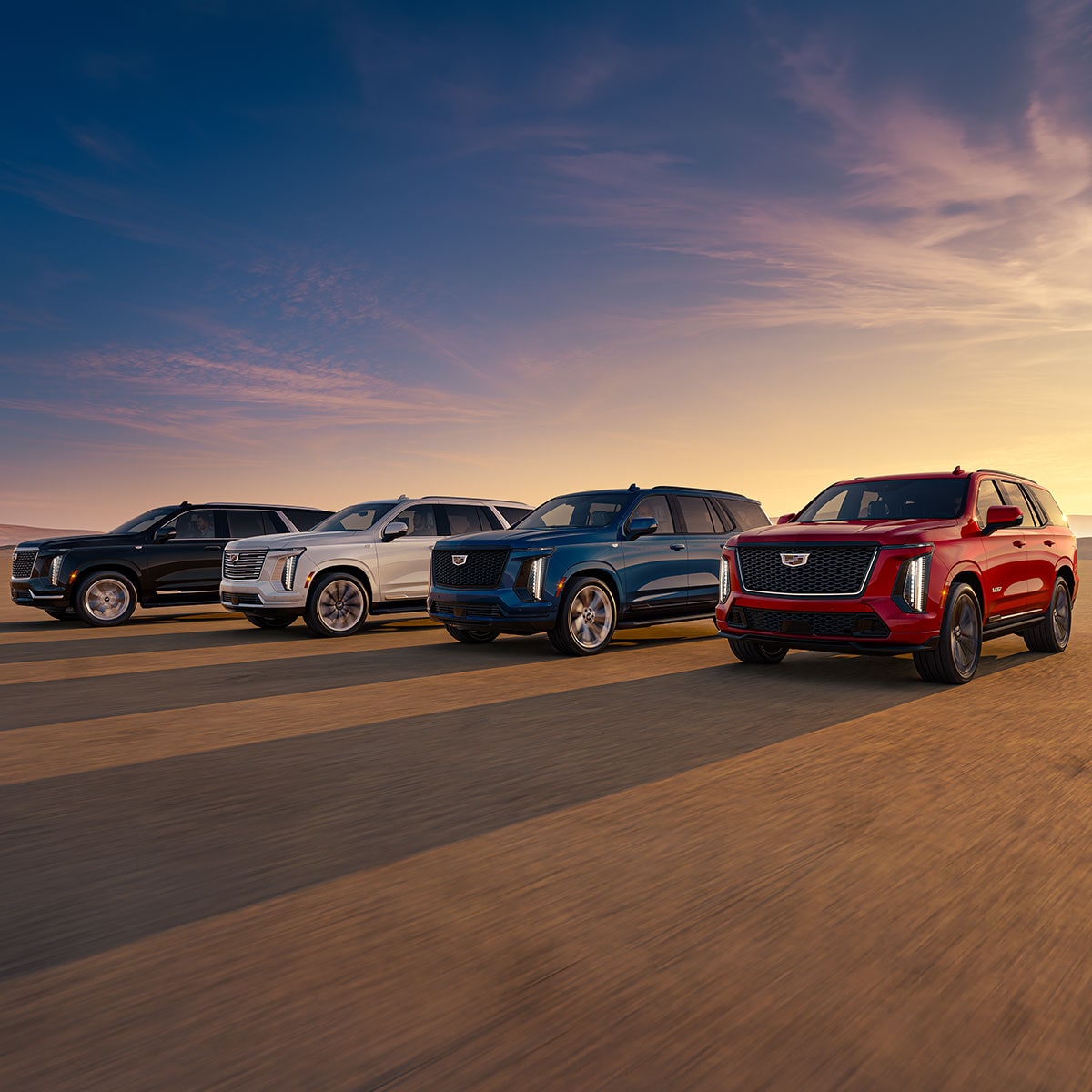 Two Cadillac CT5 Vehicles Parked Next to Each Other in the Open Desert Under a Beautiful Sunset