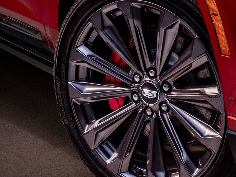 A Close up of a Cadillac Wheel with a Multi-spoke Design and Red Brake Caliper Visible behind the Rim