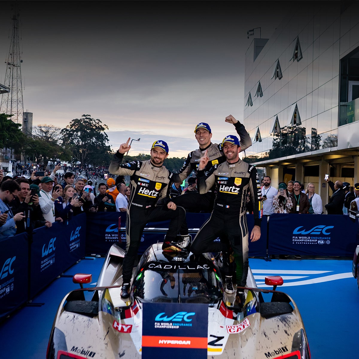 Three of the Cadillac Racing Team Members Posing on a Race Car Celebrating Cadillac’s San Paulo Win