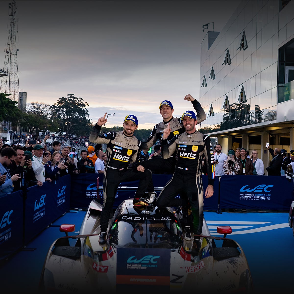 Three of the Cadillac Racing Team Members Posing on a Race Car Celebrating Cadillac’s San Paulo Win
