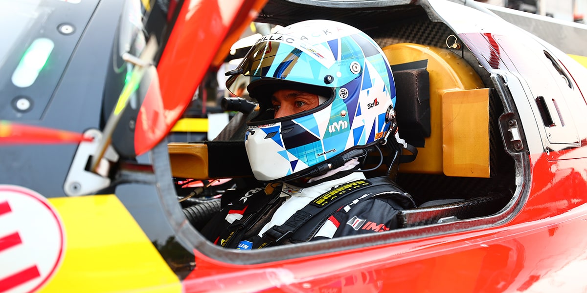 The Back of a Cadillac Race Car Driver with a Helmet On