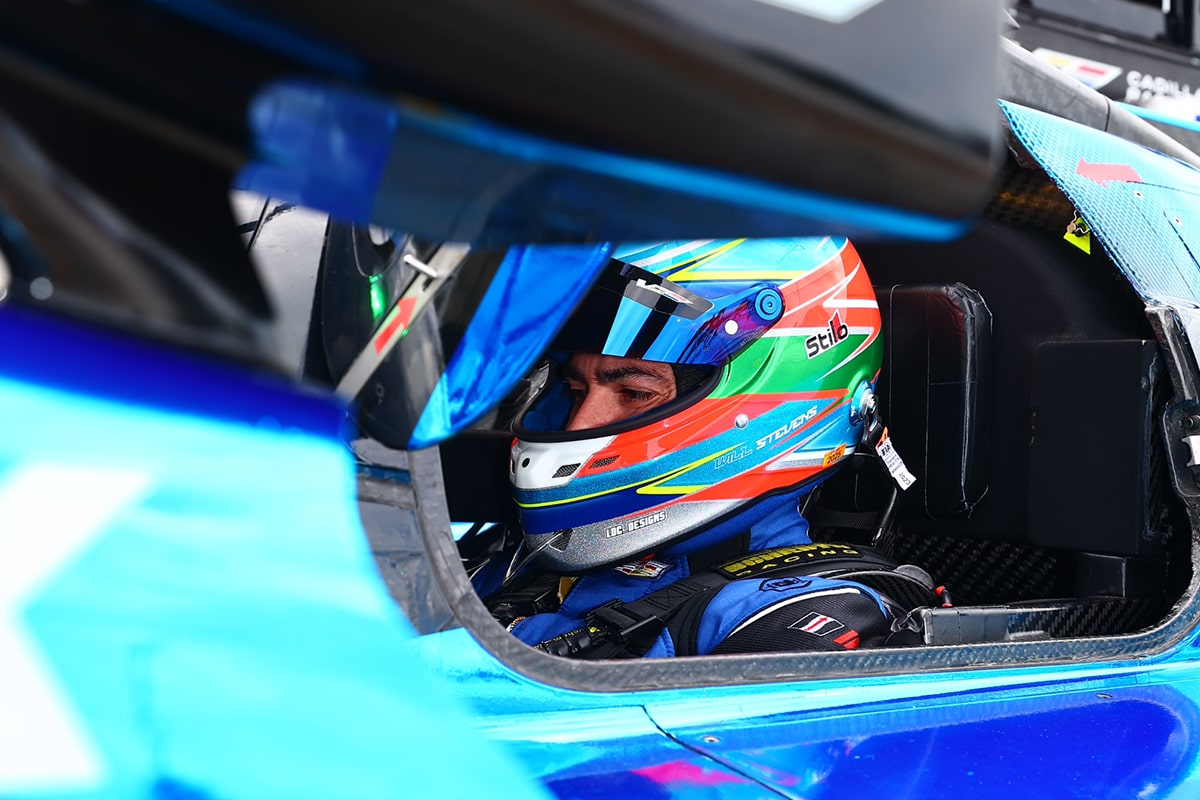 The Blue Cadillac V-Series.R Race Car Leading the Track Followed by Multiple Vehicles