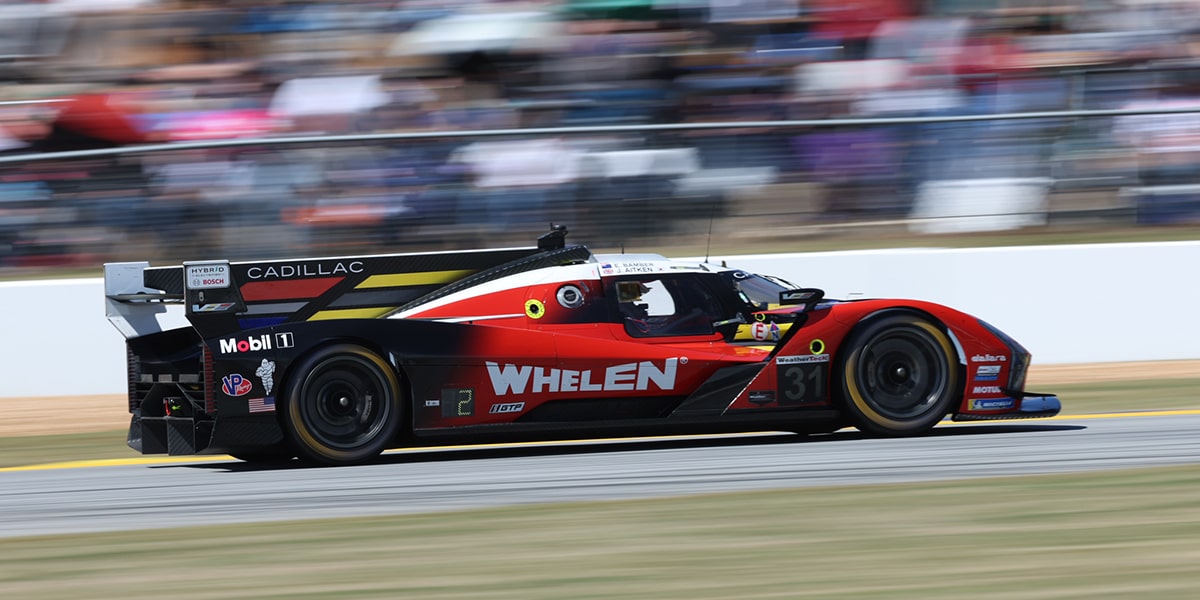 Close-up of a Cadillac Race Team Driver with His Helmet On in a Race Car