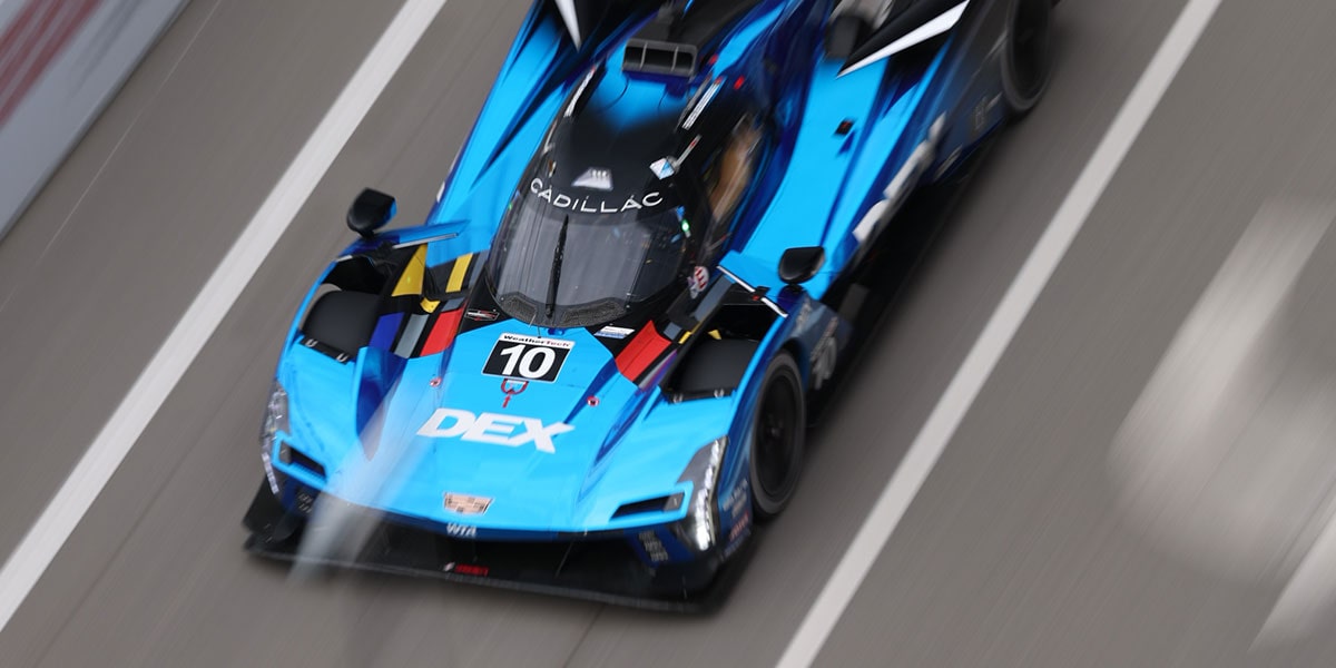 Birds Eye View of a Blue Cadillac Racing Car Speeding Down the Race Track