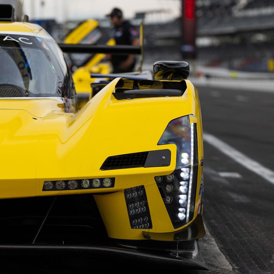 Cadillac LMDh Race Cars Racing in Line on Track