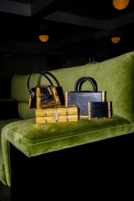 Brandon Blackwood's Beautiful and Iconic Custom Handbags Displayed on a Velvet Green Couch
