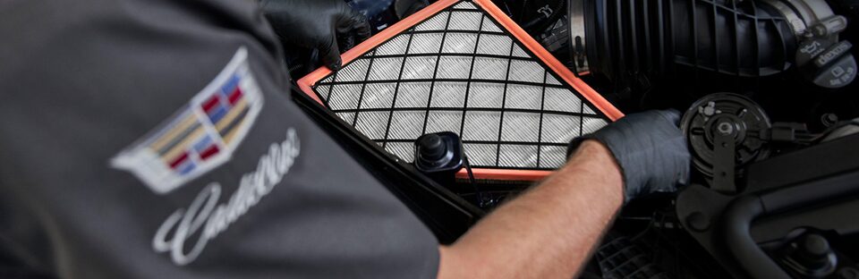 Certified Service Technician installing engine air filter