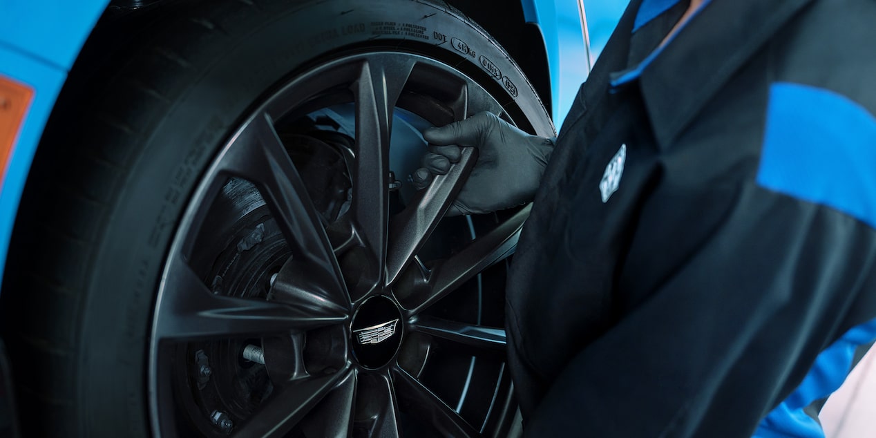 Fresh Start Tire Event Buy 3 Get 1 for $1 on Select Tires Offer to the Right of a Close-up of a Mechanic Working on a Tire