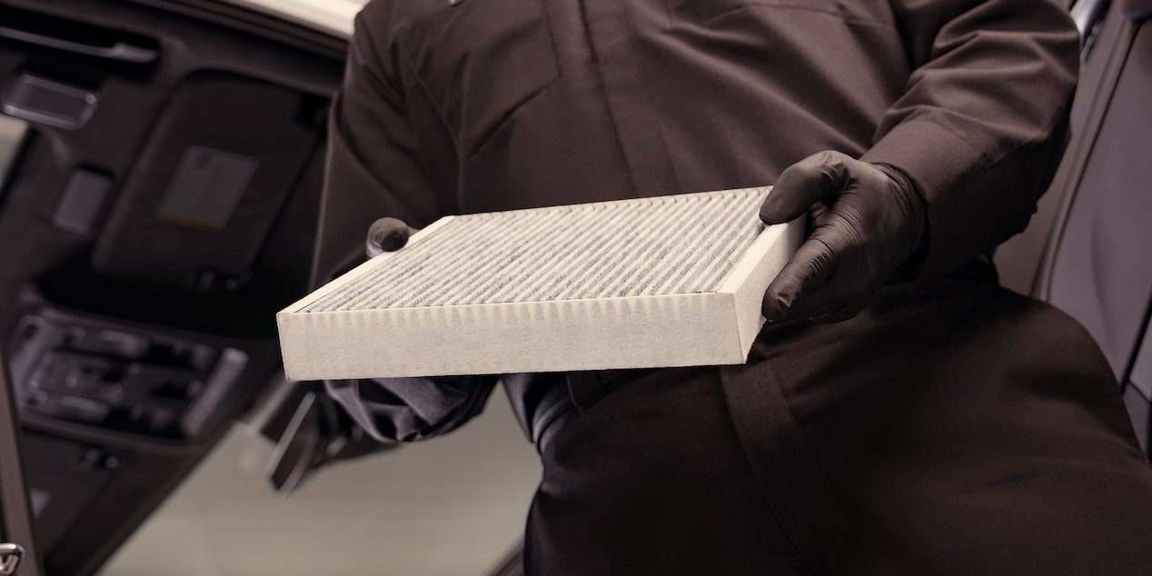 A Mechanic Is Replacing the Air Filter of a Vehicle