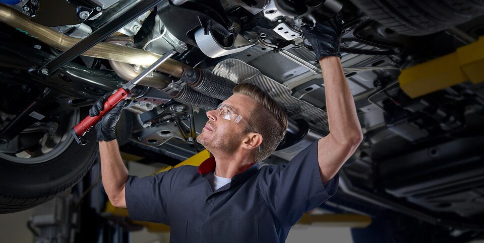 Cadillac Certified Service Technician Working Under the Hood