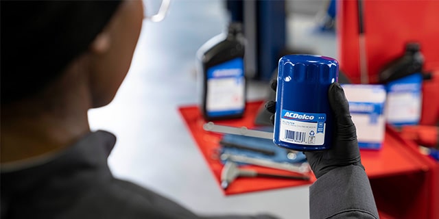 Certified Service Technician looking at ACDelco Oil Filter