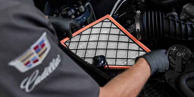 Certified Service Technician installing engine air filter