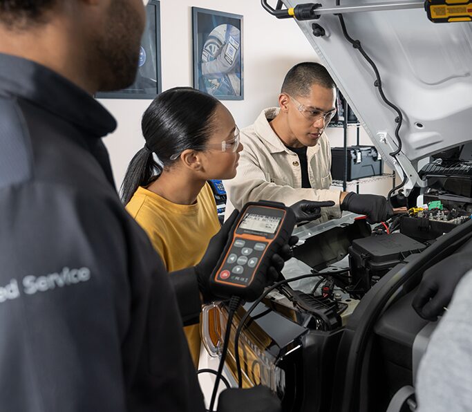 A Woman Using an Electric Vehicle Charger for Her Cadillac LYRIQ