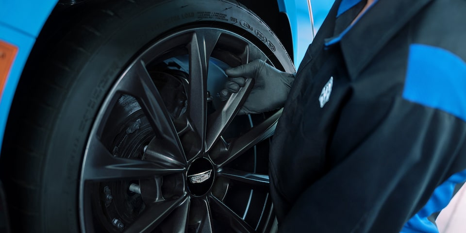Fresh Start Tire Event Offer to the Left of a Close-up of a Mechanic Working on a Tire
