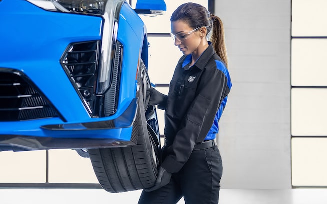 GM Cadillac certified mechanic replacing a wheel on a 2024 CTS-V
