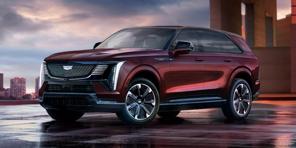 Three Quarters View of a Red Cadillac SUV under Evening Sky