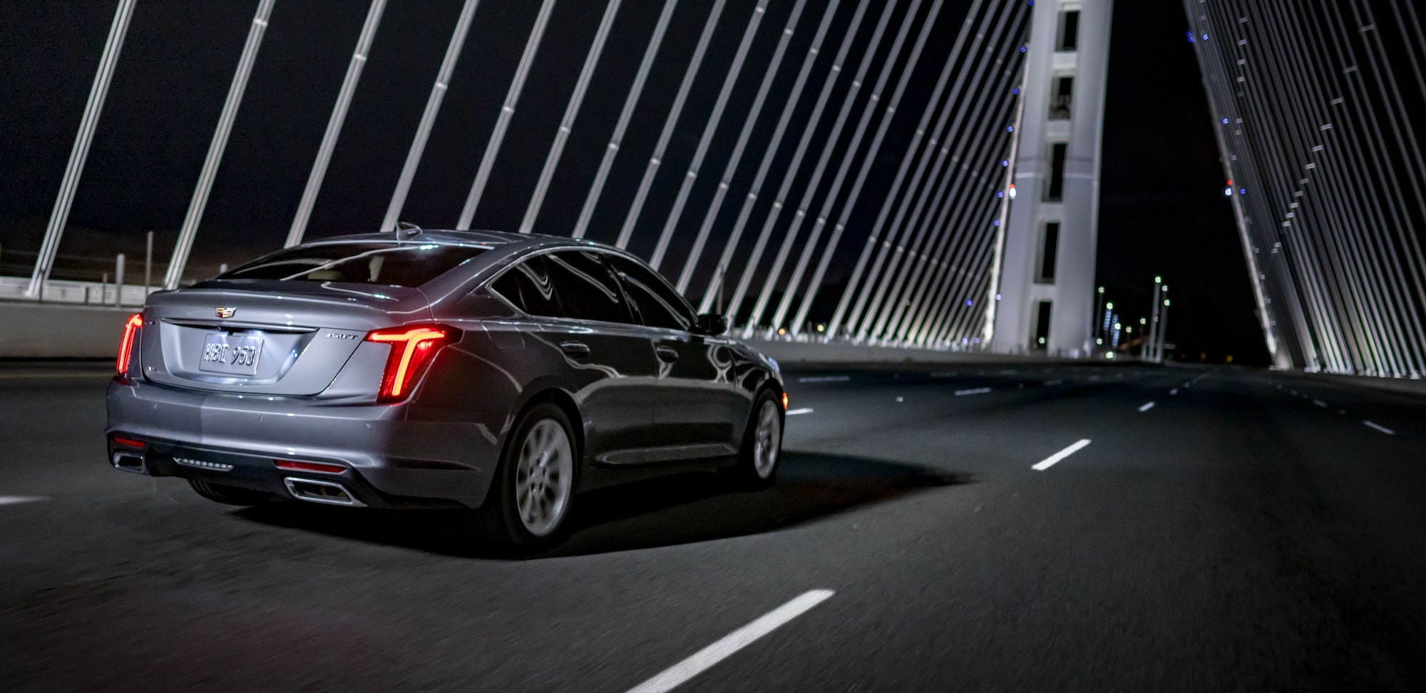 Cadillac Vehicle Rear Back Angle Driving Across Bridge