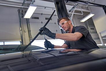 Cadillac Certified Service technician inspecting wiper blades