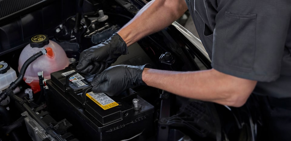 Cadillac Certified Service Technician Replacing A Vehicle’s Battery