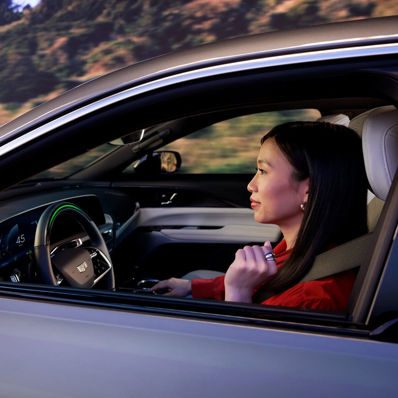 Close-up of a Woman Driving a Cadillac Utilizing Super Cruise Hands-free Driving Technology