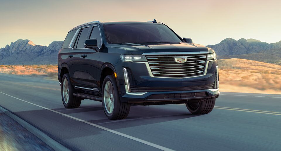 Cadillac Escalade Driving on an Empty Road through the Mountains