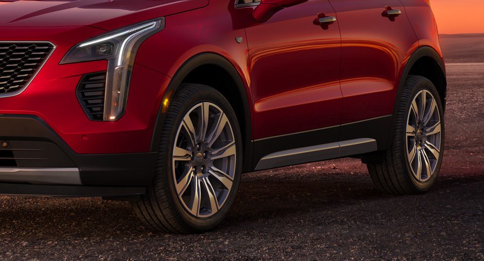 Closeup of Wheels on a Cadillac SUV Parked on Gravel Video Thumbnail