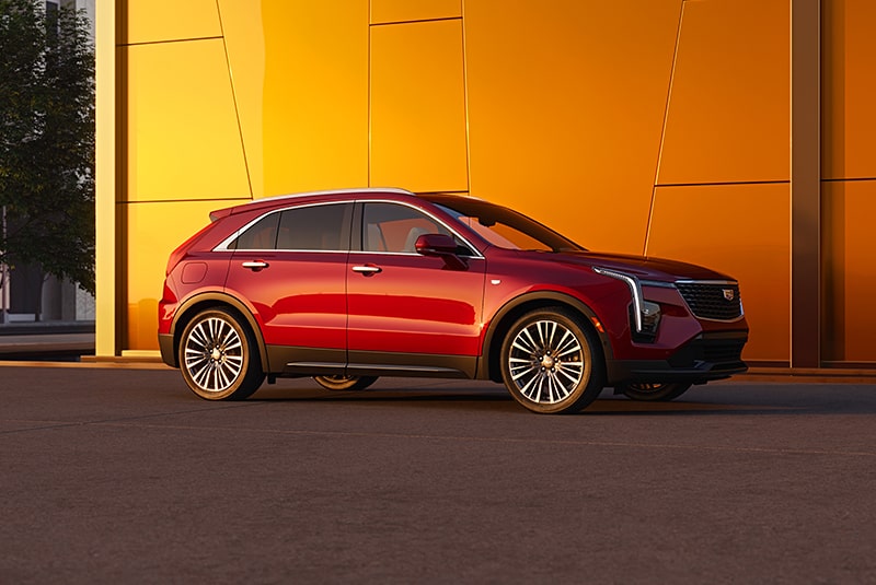Side View of a Red Cadillac SUV Parked on the Side of the Road