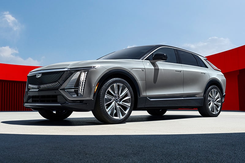 Low Angle Three Quarters View of a Silver Cadillac Vehicle Put On a Center Ground Surrounded by a Red Circular Wall