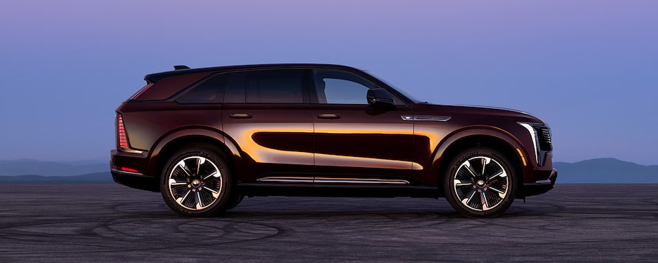 Side View of a Cadillac SUV under a Night Sky