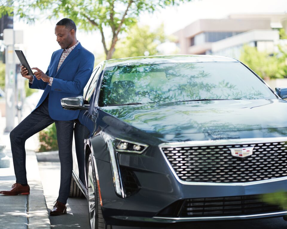 Man standing next to Cadillac